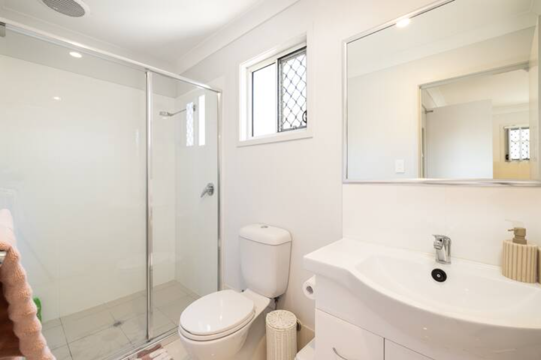 Bathroom: Stylish bathroom with walk-in shower, vanity, and clean finishes 