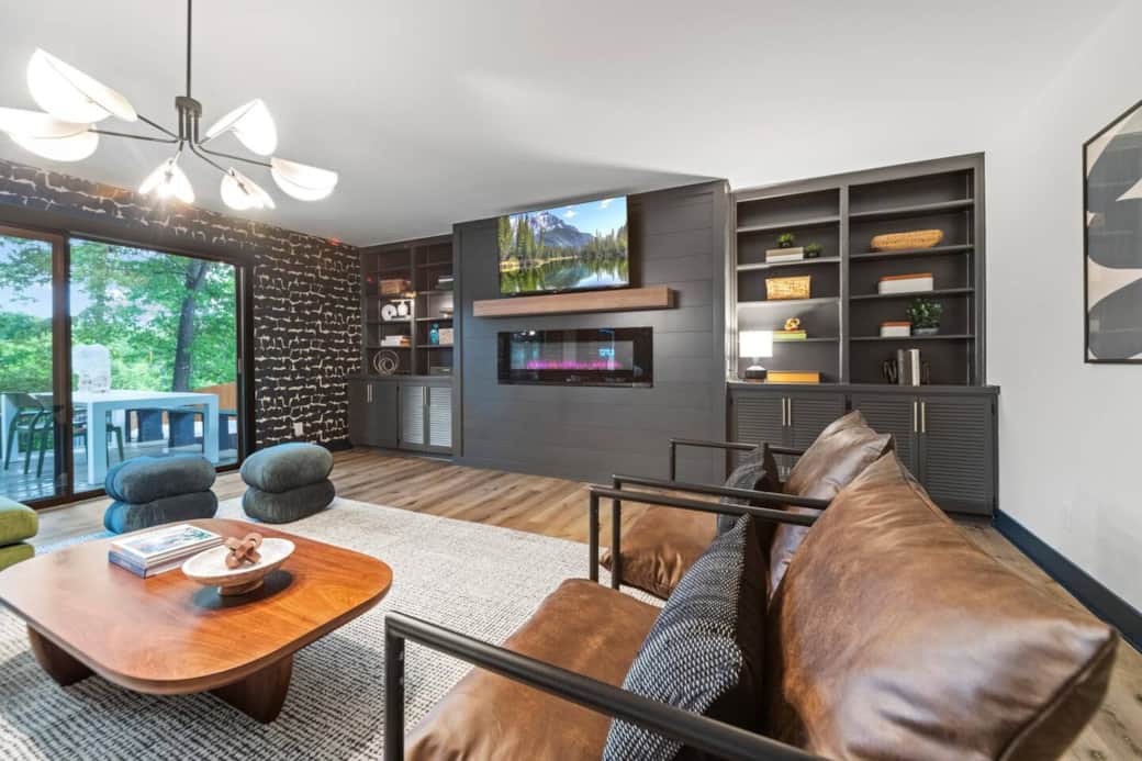 Cozy living room with plush seating, fireplace, 55” TV & moody-modern vibes—made to feel like home.