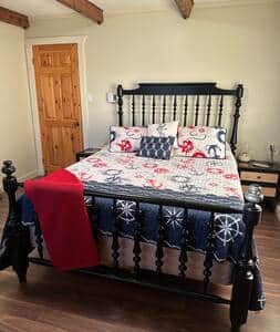 Large Master bedroom includes a comfortable; bed, pillows, lovely linens and luggage racks.