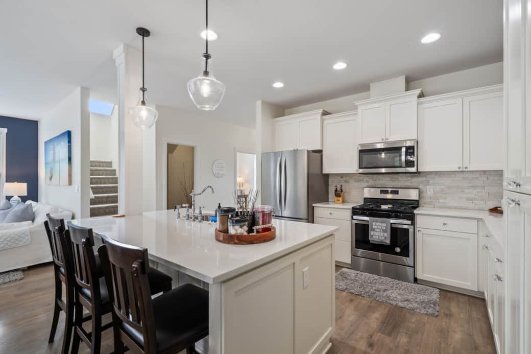 Cooking is a joy in this kitchen with quartz countertops, stainless steel appliances & large island.