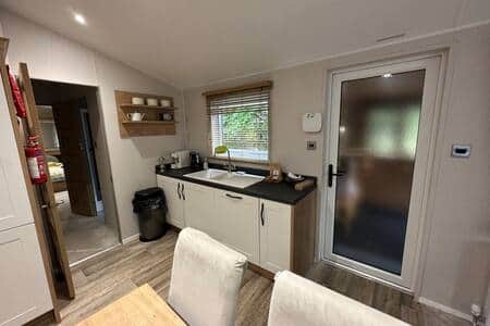 Kitchen leading to bathrooms and bedrooms