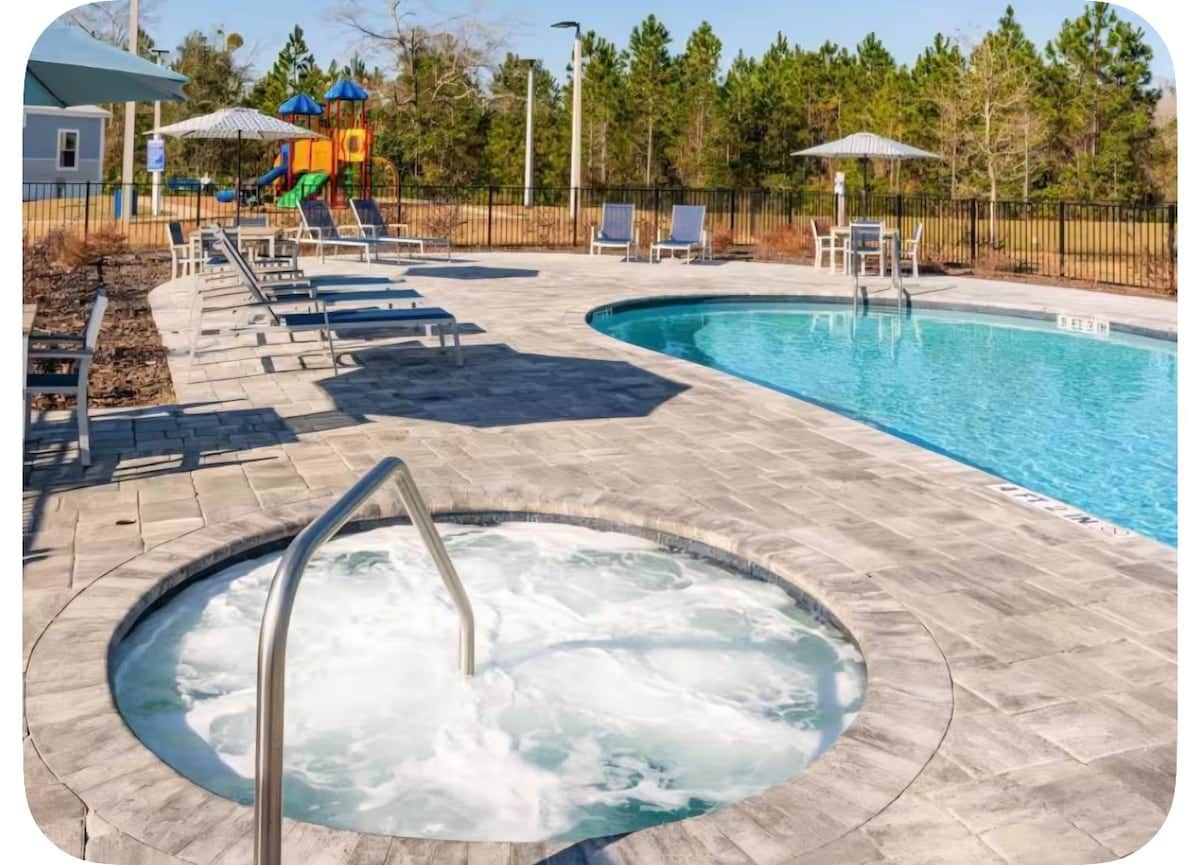 Enjoy the shared outdoor pool and adults-only hot tub at Pecan Park RV Resort.