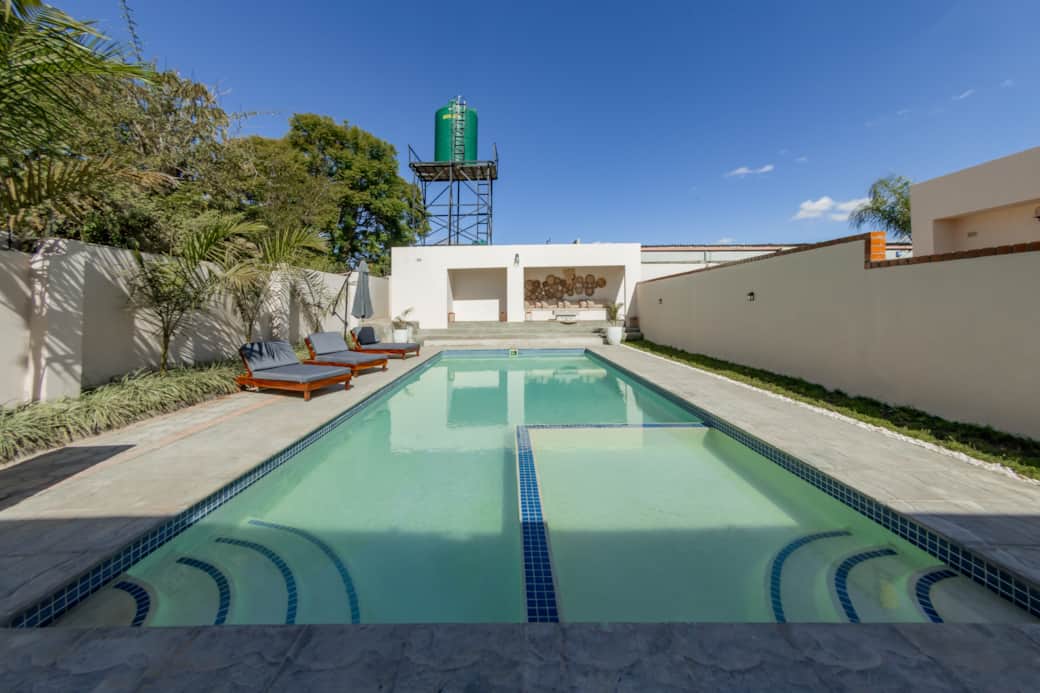 Shared outdoor swimming pool with sun loungers