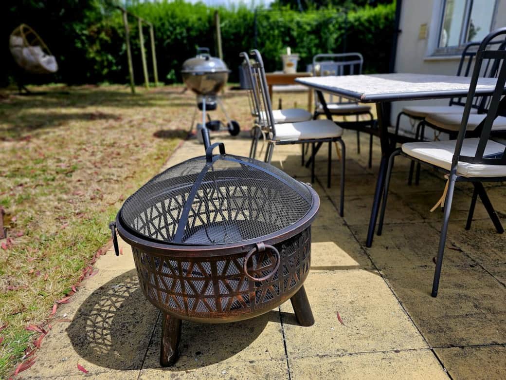 Everything to enjoy outdoor dining and relaxing including fire pit, plenty of seating, table, BBQ and sofas