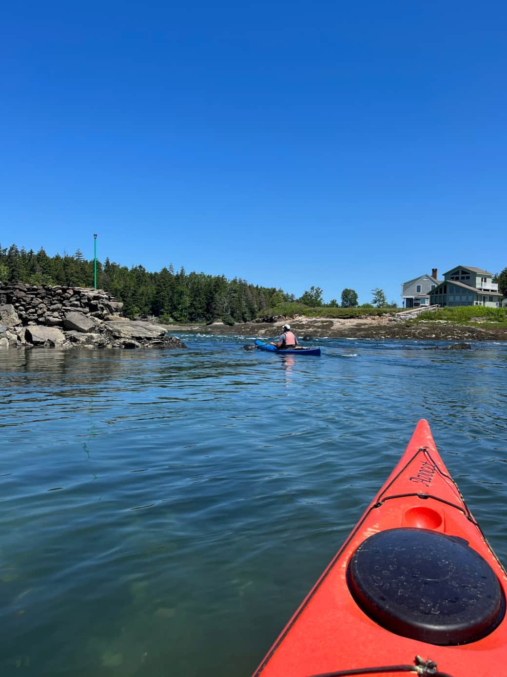 Kayaking the tidal entrance of Basin Cove