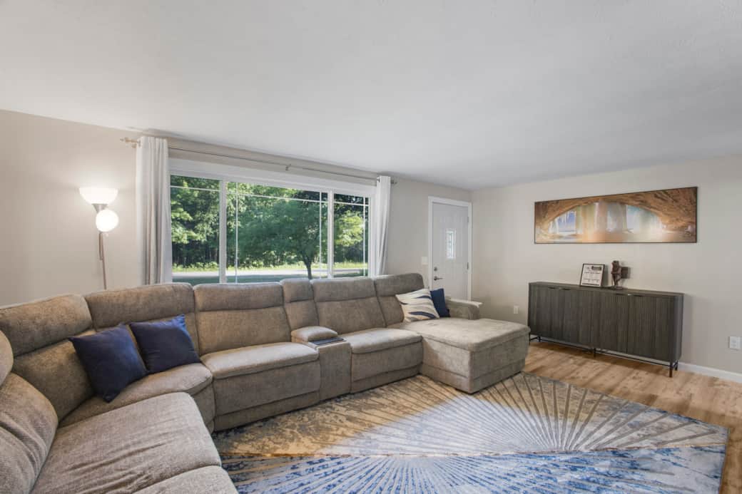 Bright, open living space with plush seating and abundant natural light.