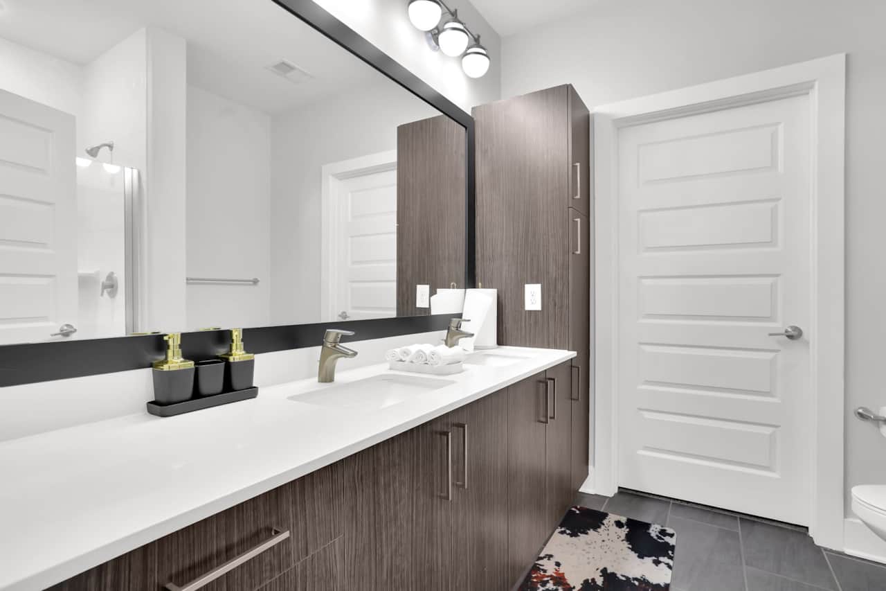 Primary Bathroom Features a double vanity and plenty of storage space.