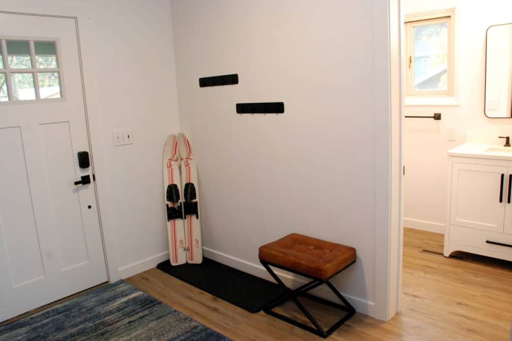 Entryway with coat racks, shoe tray, and bench
