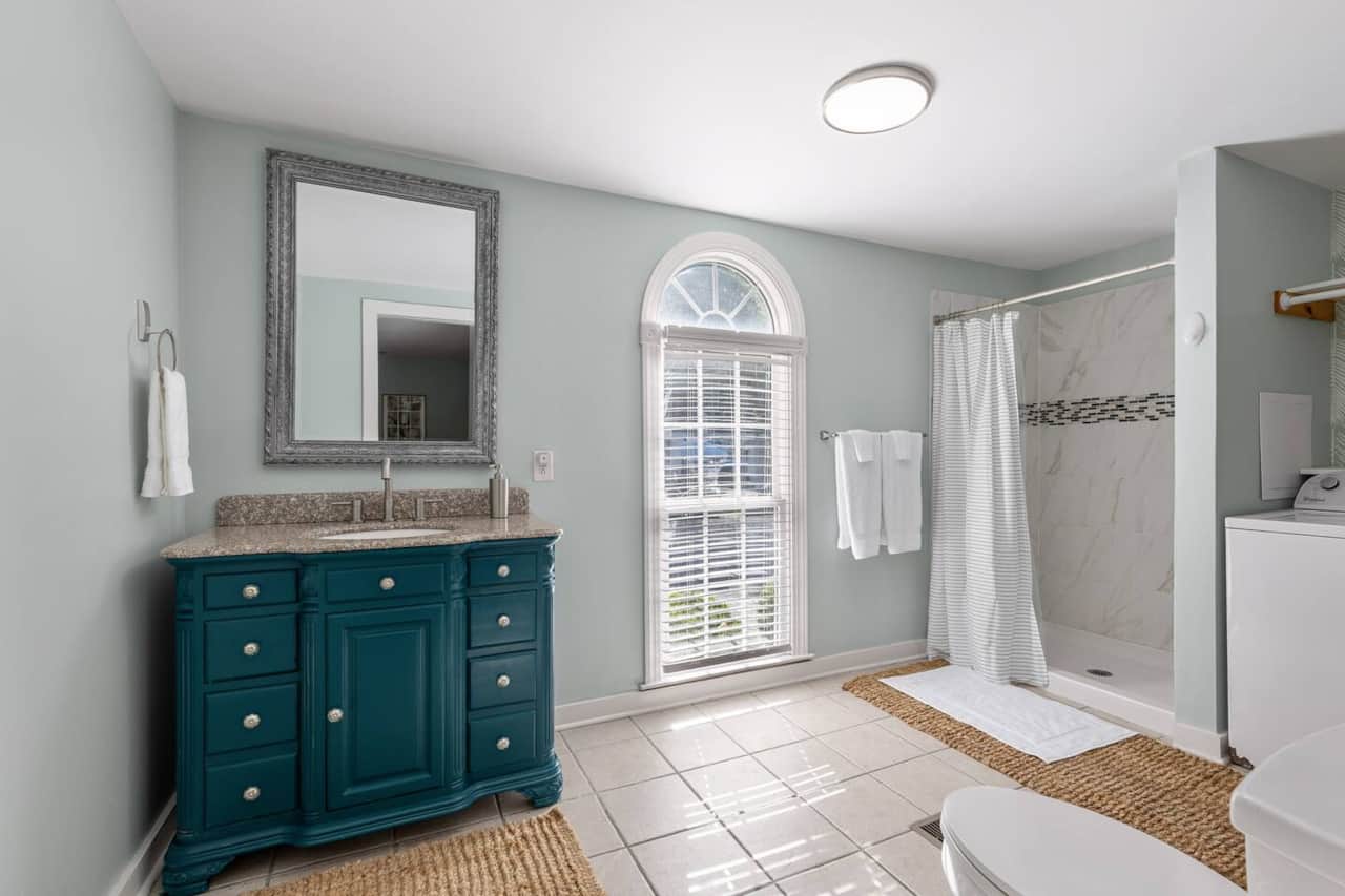 Primary Bathroom with vanity and walk-in shower.  Body wash, shampoo and conditioner are provided.