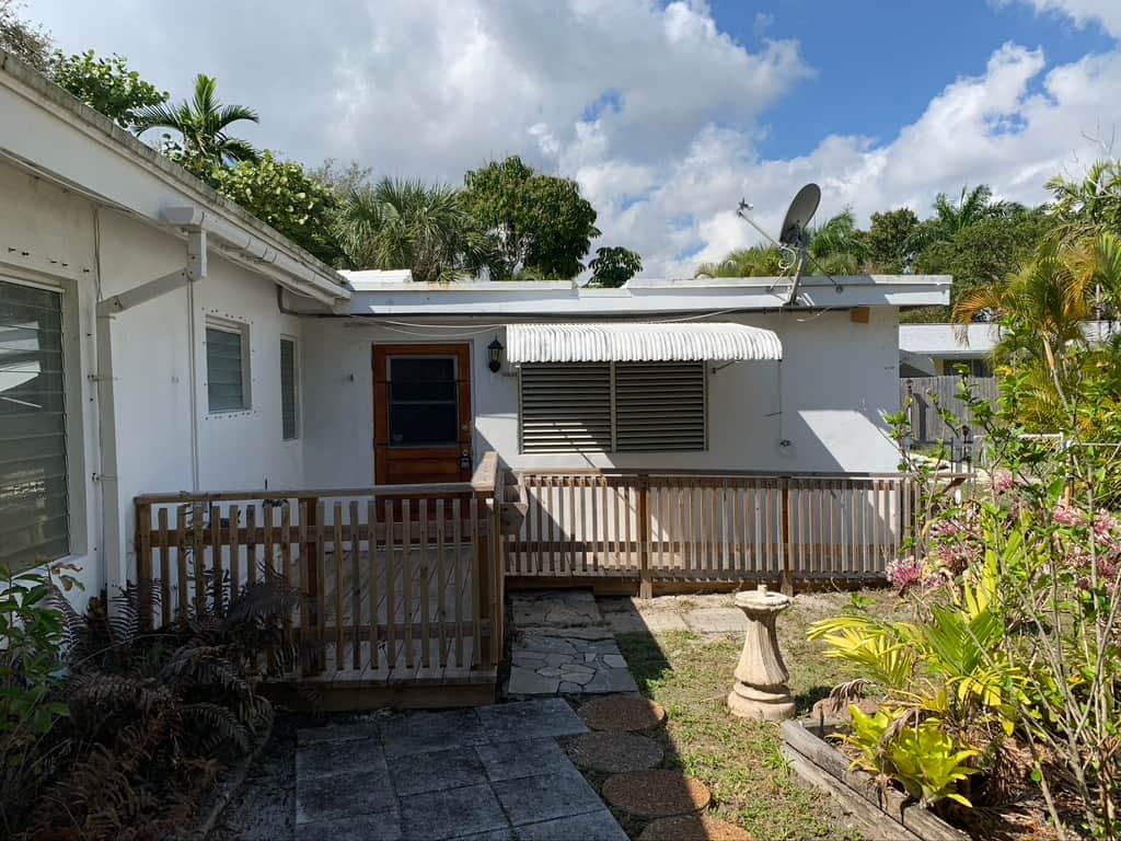 Casa Citron courtyard before renovation with wooden accessibility ramps and minimal landscaping