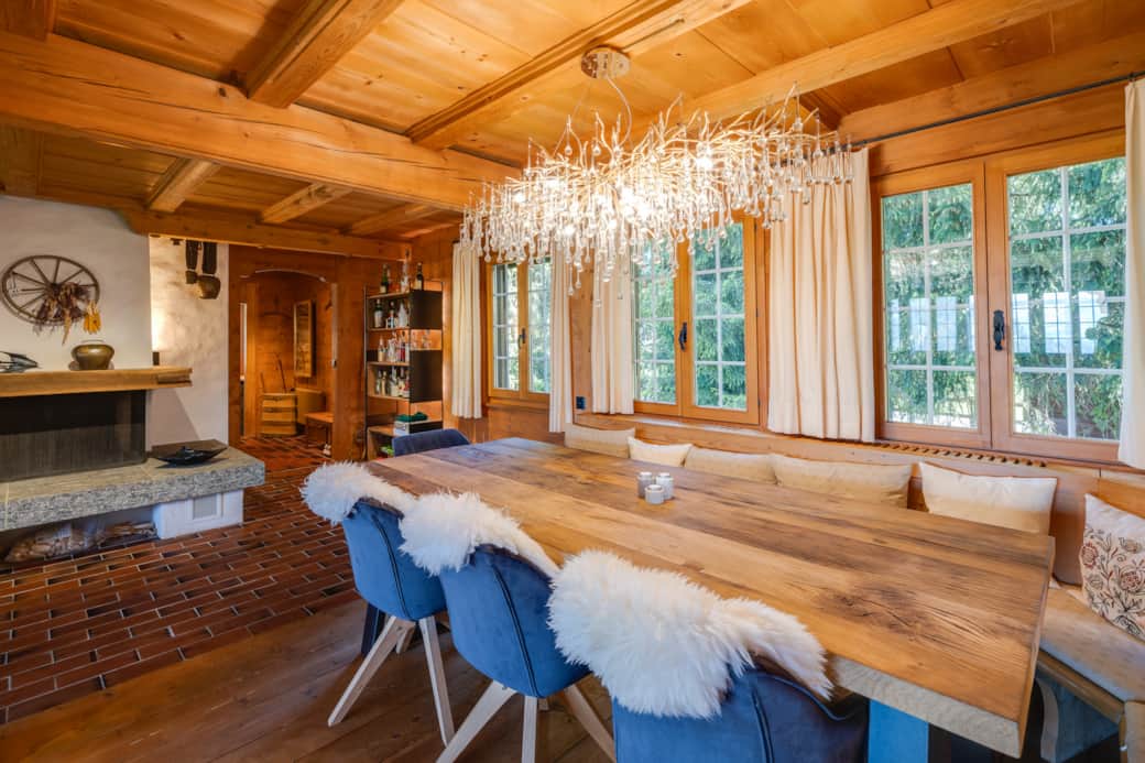 Large dining room with a cozy fireplace and massive oak table, seating 10 people.