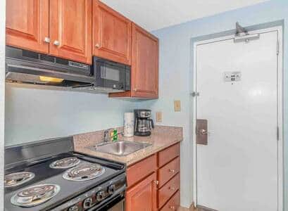 Fully Equipped Kitchenette with Full-Size Fridge Includes stovetop, microwave, refrigerator, coffee 