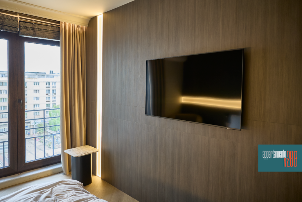 Flush-mounted Smart TV on dark wood feature wall, designer apartment, Iași Flush-mounted Smart TV on dark wood feature wall, designer apartment, Iași