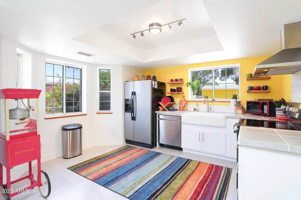 Well-lit kitchen with windows and open space—ideal for relaxing mornings and home-cooked meals