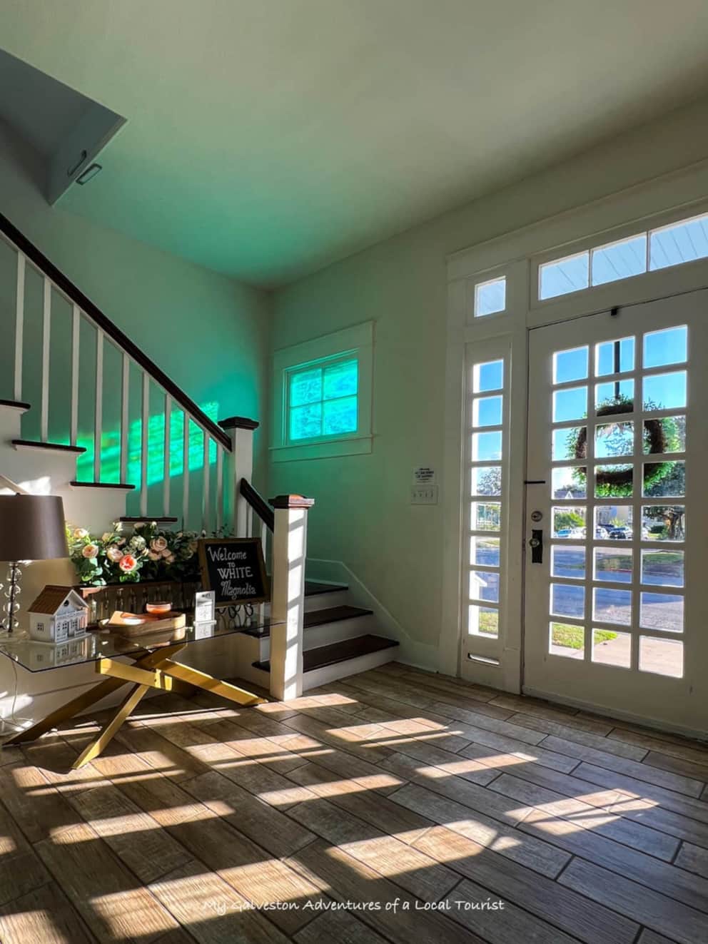 Cozy living room seating details with soft textiles and natural light at White Magnolia Galveston