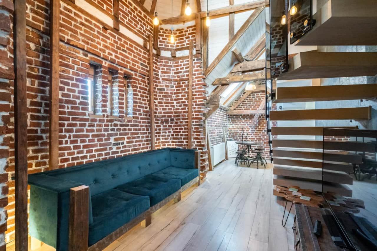 Stylish living area with exposed brick walls in Central Bucharest duplex