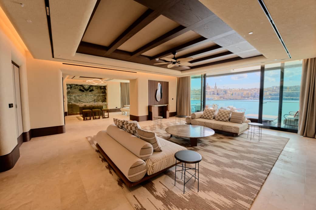 Spacious living area with sea views and floor-to-ceiling windows.