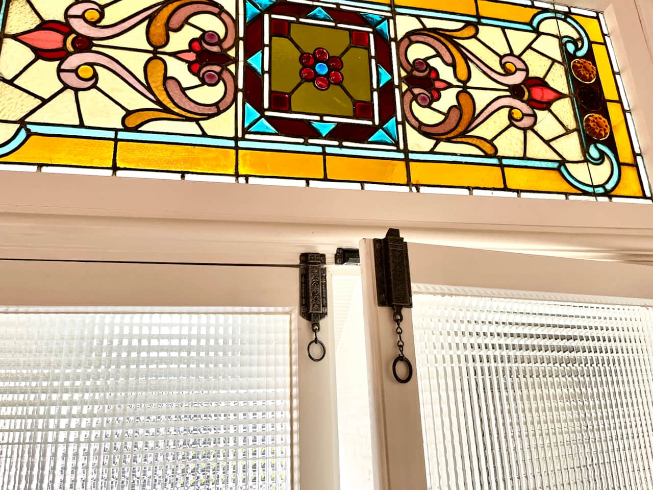 Original stained glass cleaned and old door latches fully restored