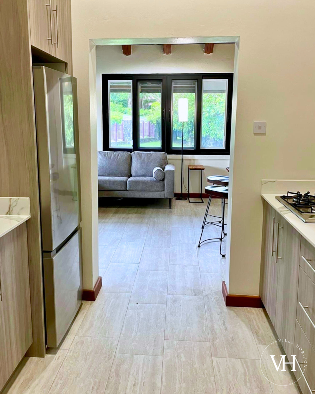 Full kitchen with fridge, stove, sink, cooking essentials, and a complimentary coffee station.