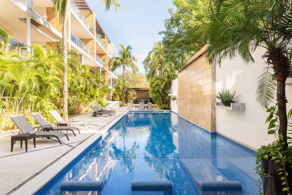 The saltwater pool is surrounded by vegetation and has ample loungers are available for guest use