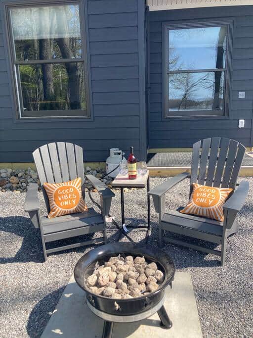 Adirondack chairs and side table for relaxing next to the water and firepit Adirondack chairs and side table for relaxing next to the water and firepit