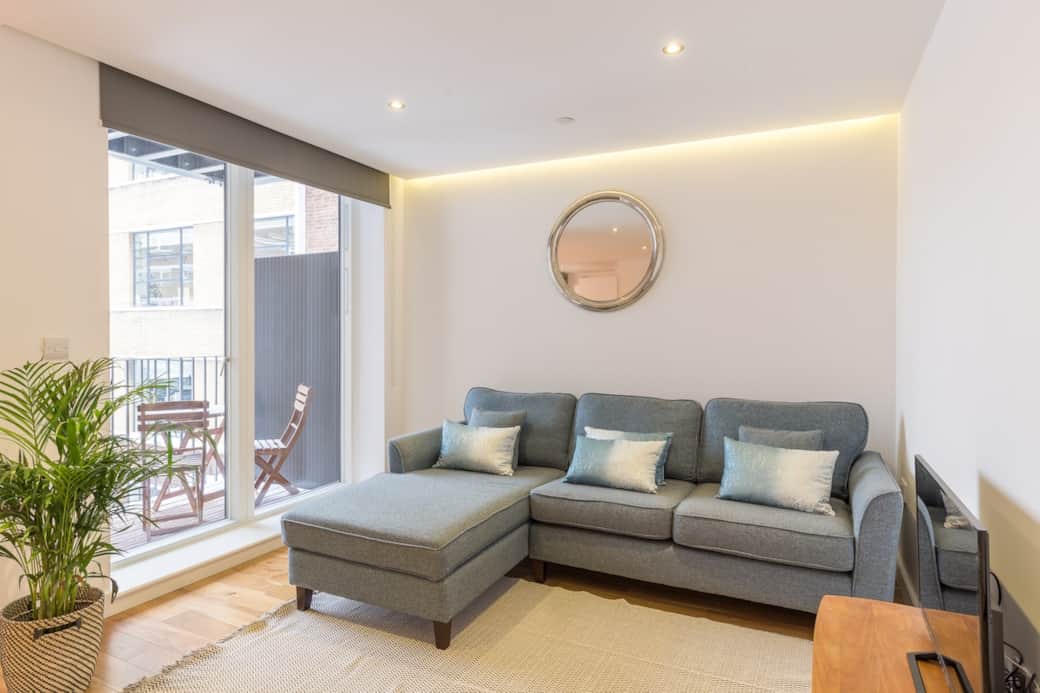 Open plan lounge with a large comfortable sofa and outside balcony perfect for summer nights. Smart TV available with access to all major subscription apps. 