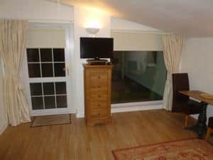 Smart TV and table with chairs to eat and work on 