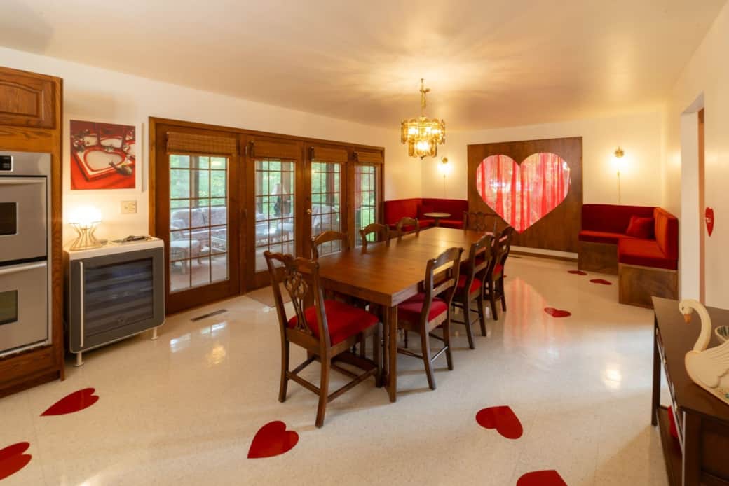 Romantic dining room with heart window, Rocco drink fridge, and plenty of seating for groups