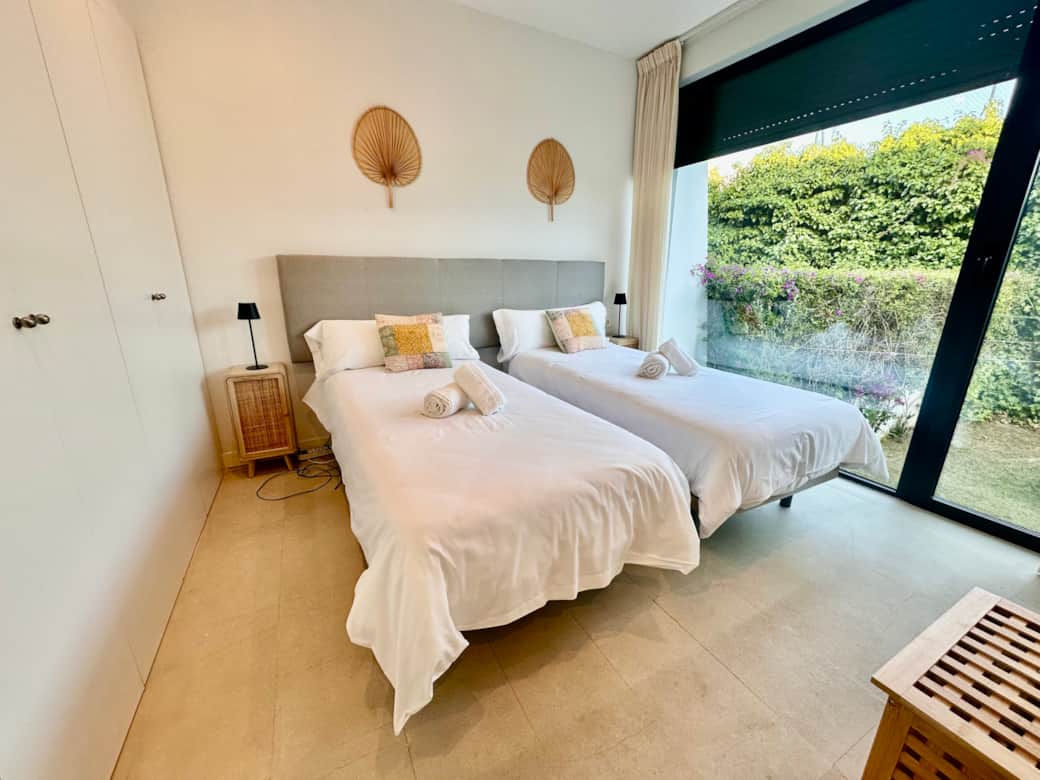 Bedroom 2 with twin beds and garden view