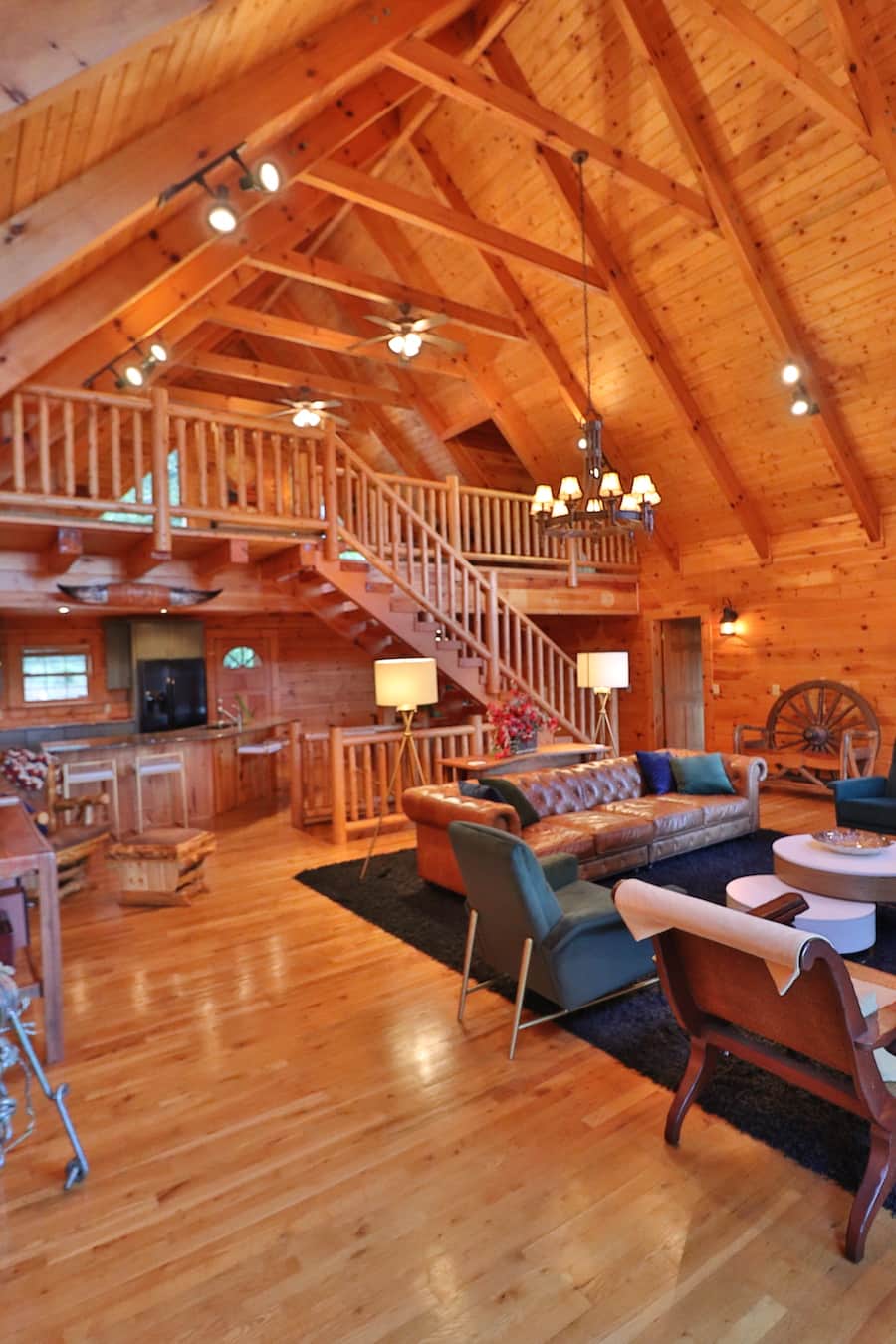 Modern meets rustic living room lodge w/floor to ceiling fireplace overlooking mountains.