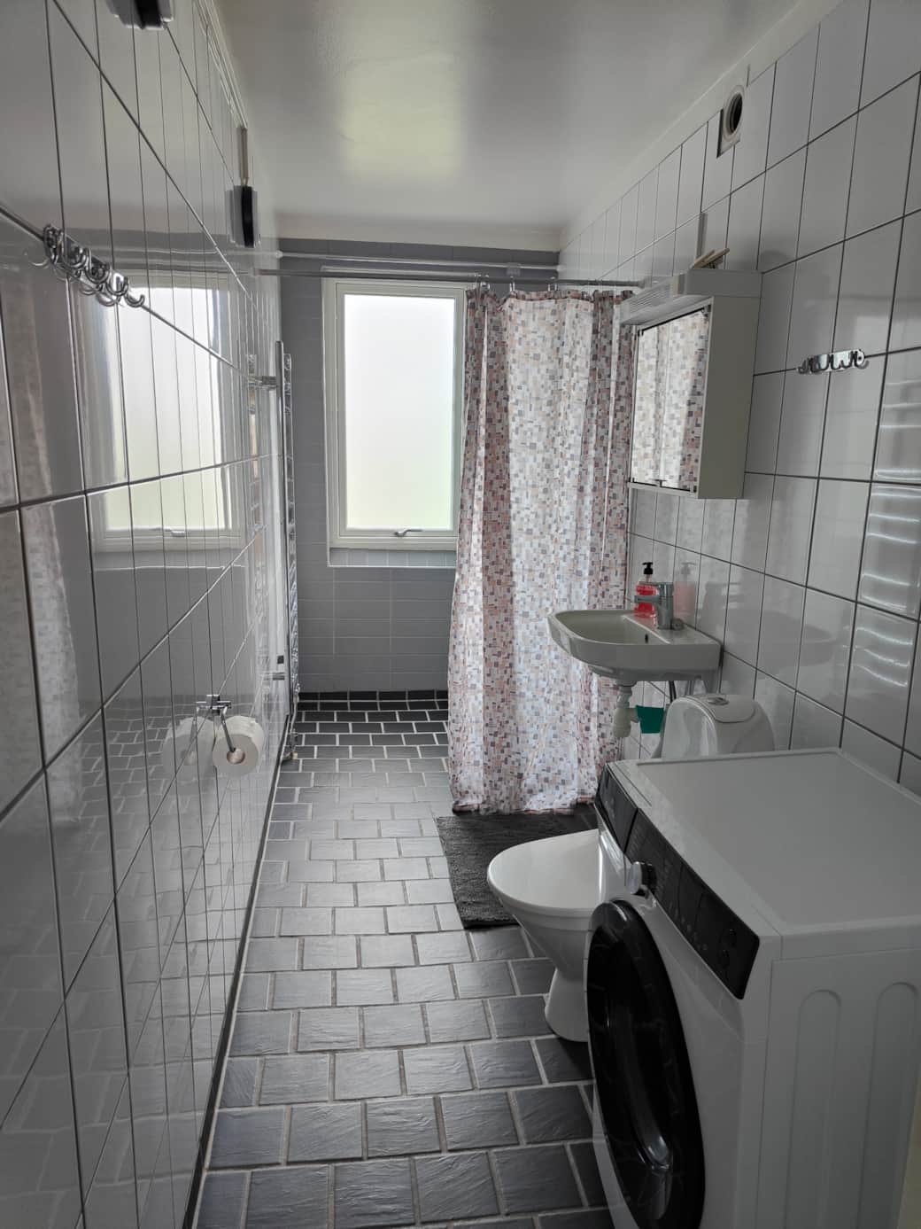 Bathroom with washing machine and shower Bathroom with washing machine and shower