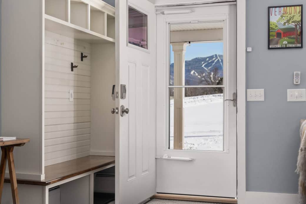 This entryway warmly welcomes you into the open concept living space while providing space for shoes, coats and other items. It also showcases the beautiful mountain views from inside and out!