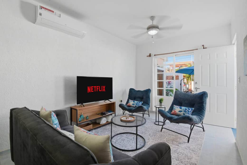 Relax in our cozy living room featuring a comfy couch and two chairs—perfect for movie nights with Netflix and other streaming services. Enjoy AC, a ceiling fan, books to read, and direct access to the patio and pool.