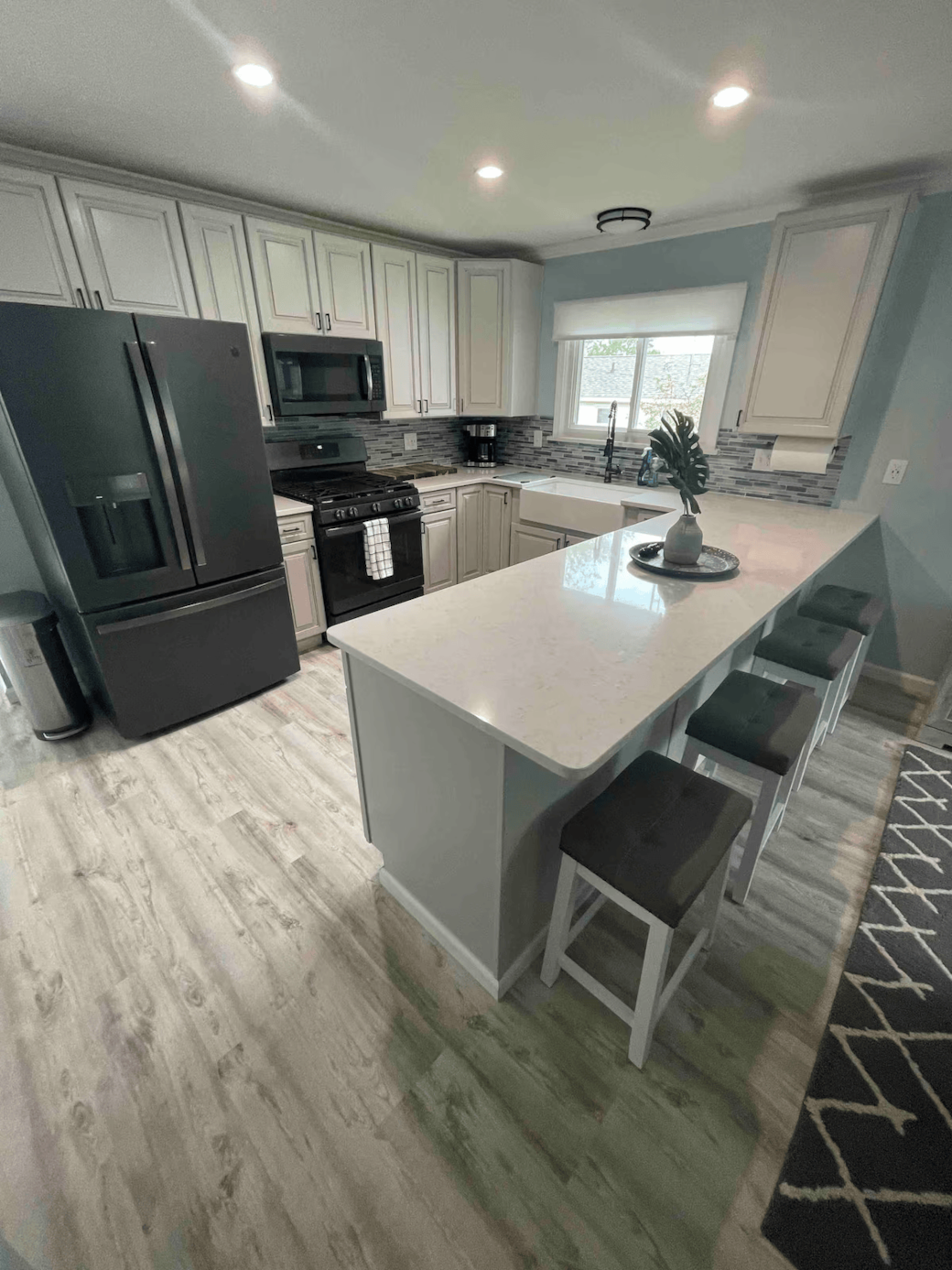 Well-equipped kitchen with microwave, kettle, and cooking basics