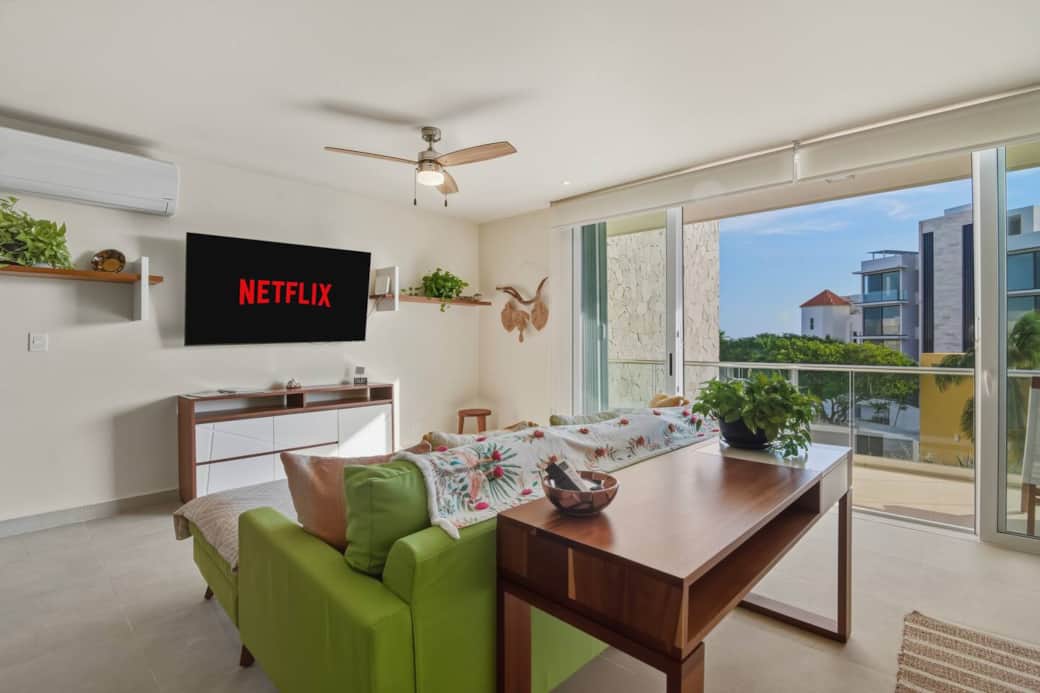 A cozy living room opens to breathtaking views and features a smart TV for your favorite streaming services, room-darkening shades, A/C, and a ceiling fan. A work desk is ideal for working while you travel, and glass doors lead to a private balcony.
