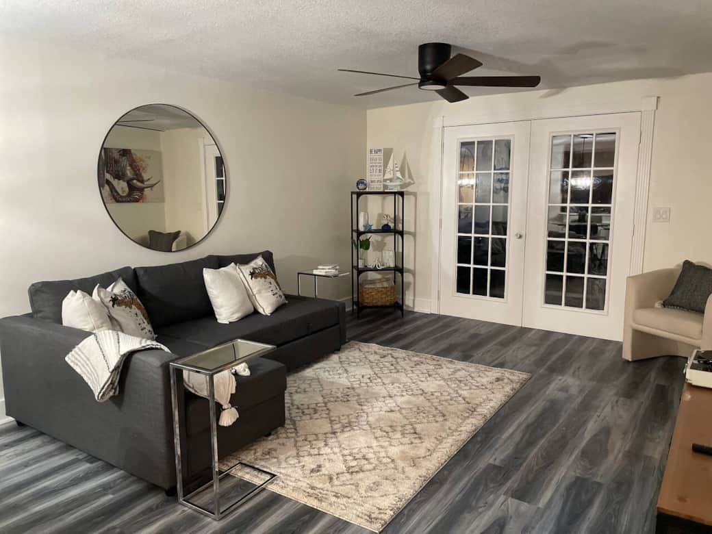 Cozy living room with a large L-shaped sofa with pullout bed and soft throw—perfect for relaxing.