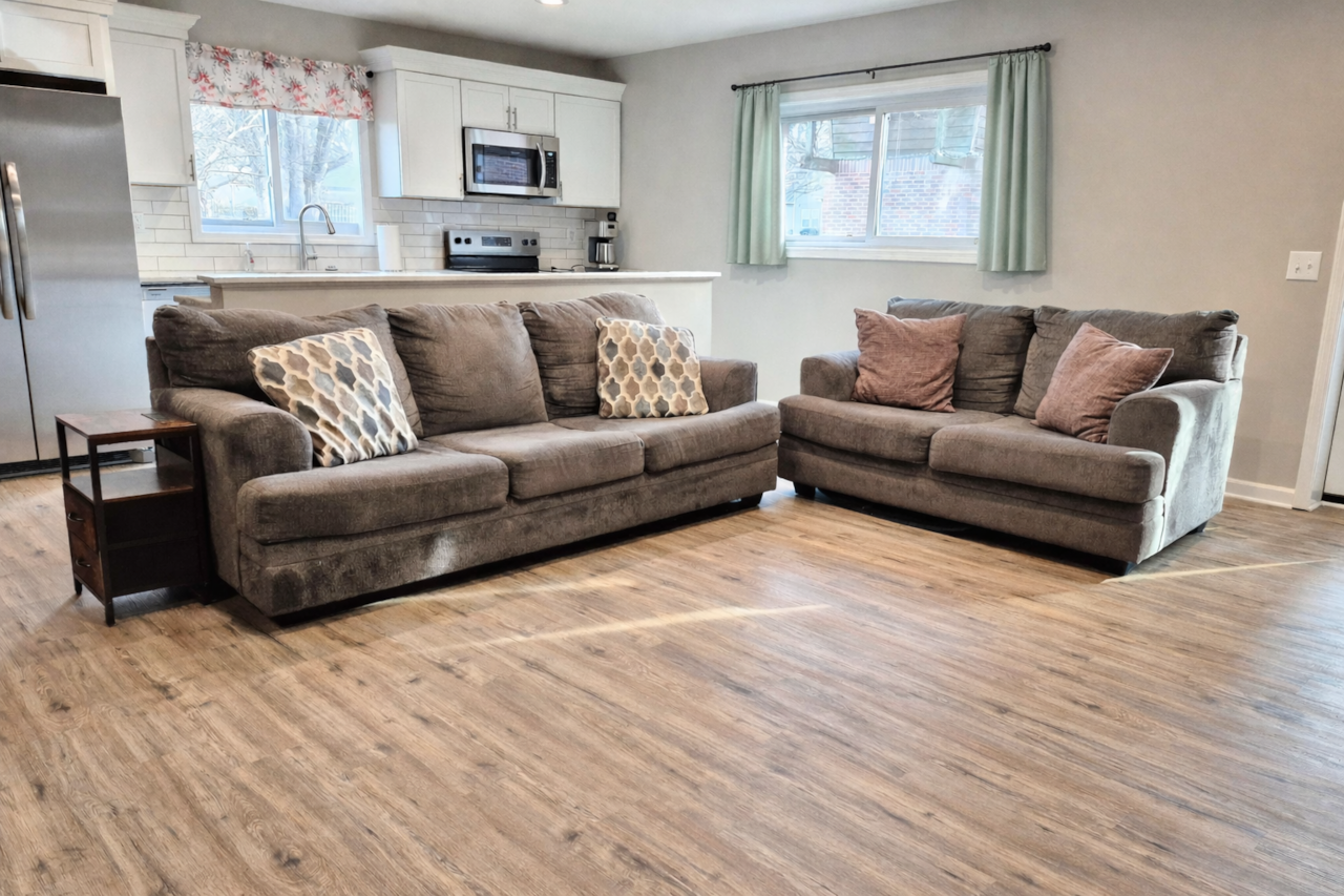 Cozy living room with two couches and Roku TV, perfect for relaxing nights.