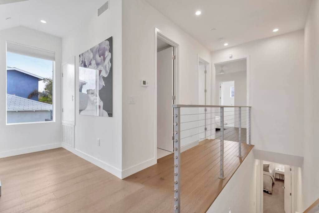 Hallway to half bath, laundry room, and master bedroom.