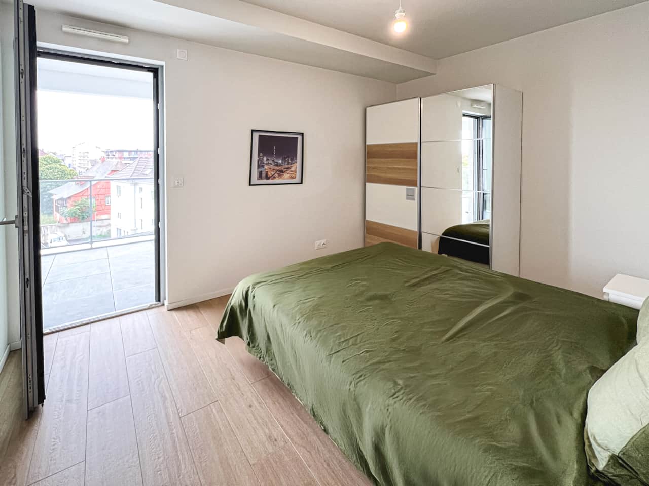 Large bedroom opening onto balcony with open view