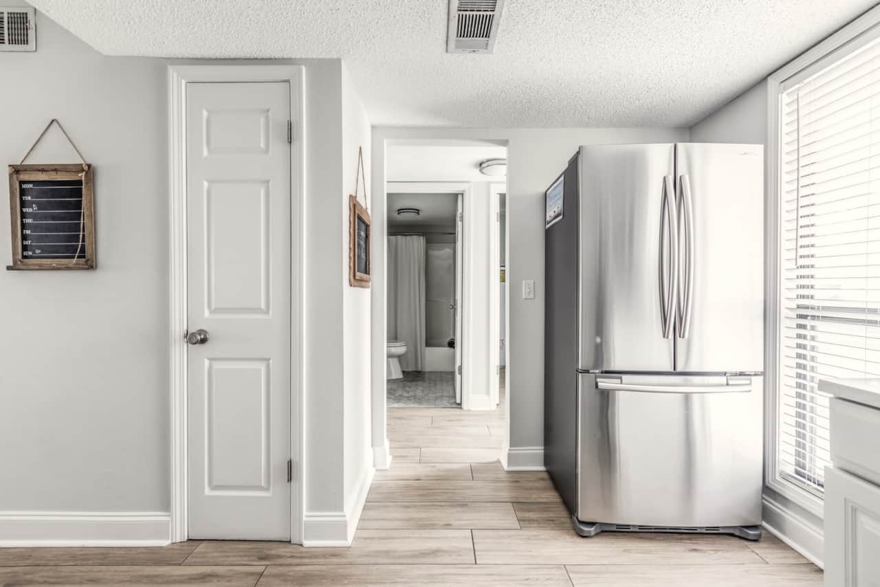 The kitchen is just off the main entrance and across from the hall bathroom. 