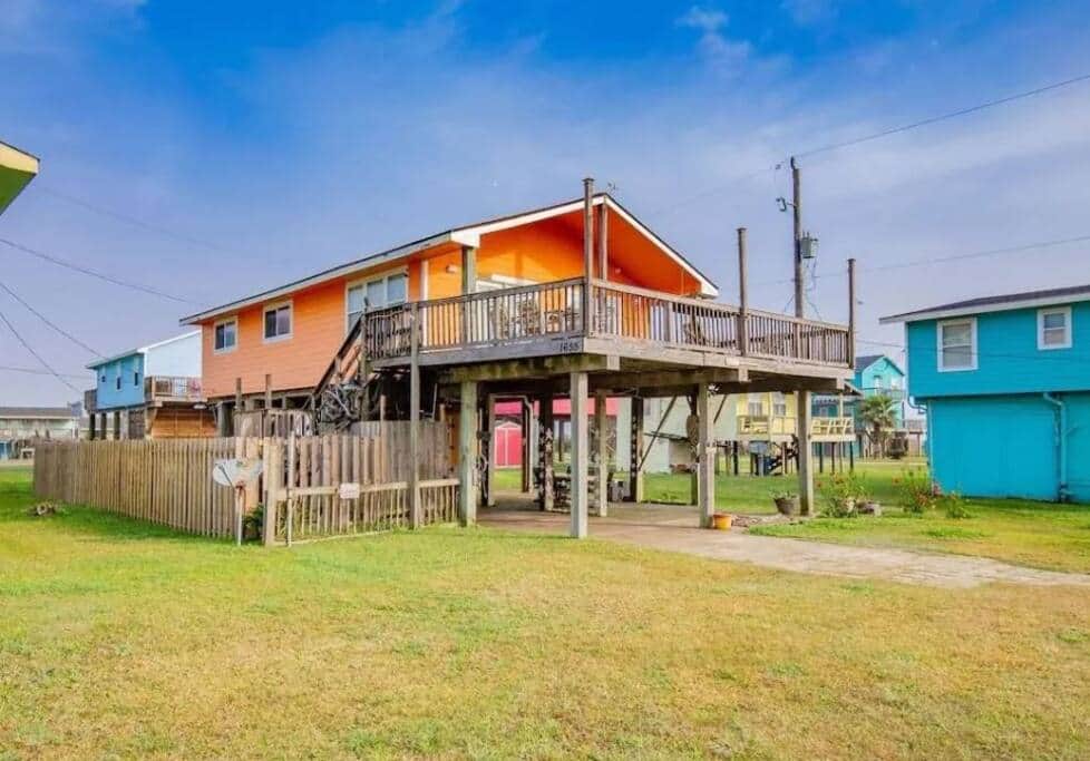 Front of SunRay beach house, under home parking area, and fenced yard.