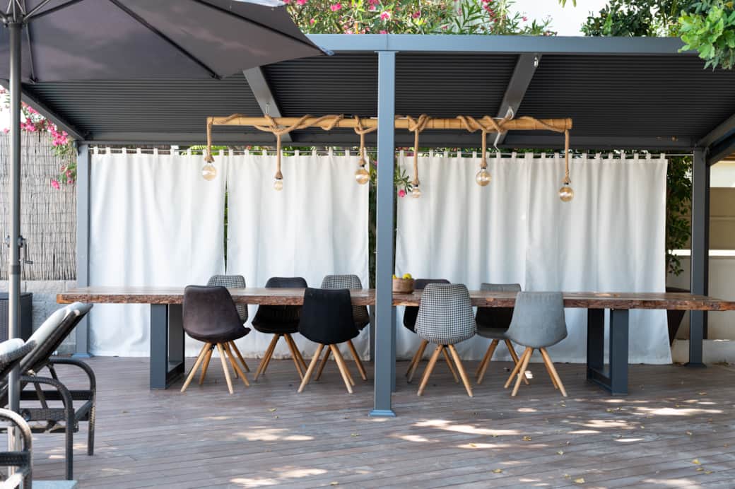 Outdoor dining area under covered terrace at Casa Guindilla in Portals Nous, Mallorca