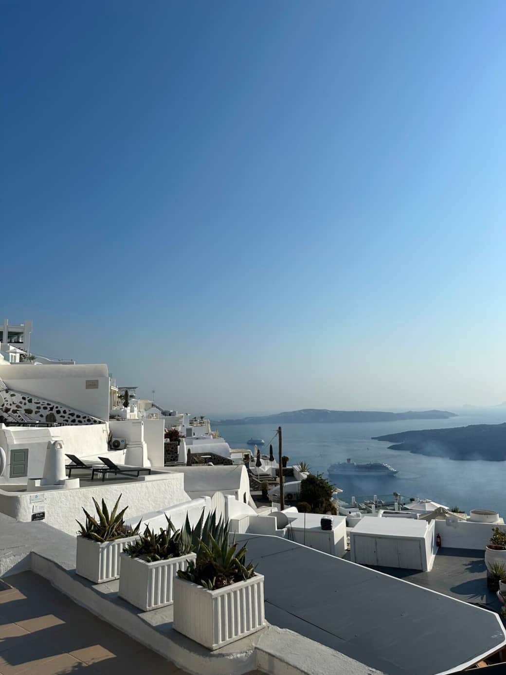 Second private Santorini terrace ideal for relaxing with sunset views.