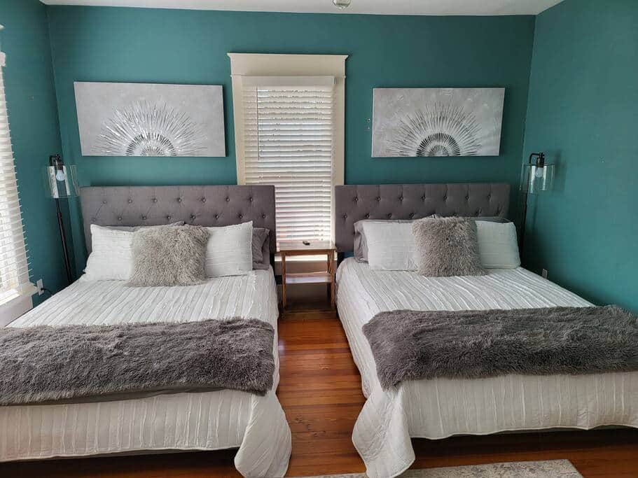 Bedroom 2. Two Queen size beds, dresser, and sleeping porch.