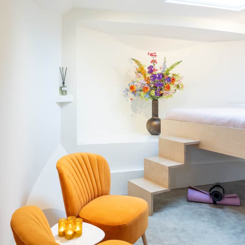 Inside the boat suite of our Amsterdam houseboat B&B, with a king-size bed and seating area