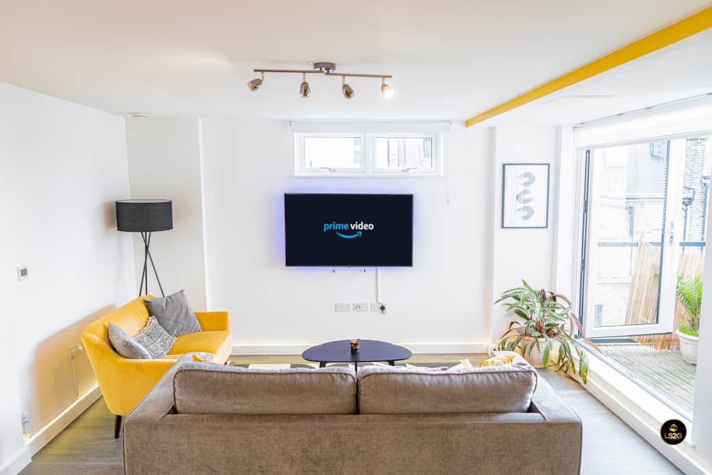 Living area with Balcony, Sofa bed and 55" Smart TV Living area with Balcony, Sofa bed and 55" Smart TV