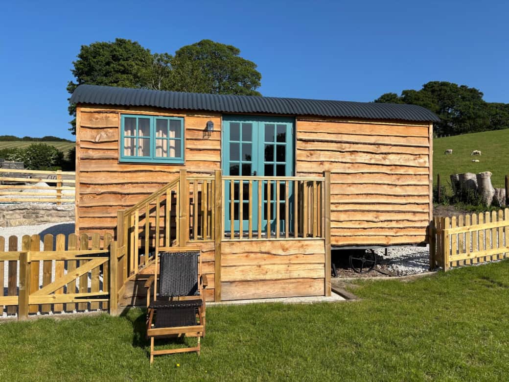 Private fenced garden area with decked entrance and countryside views.