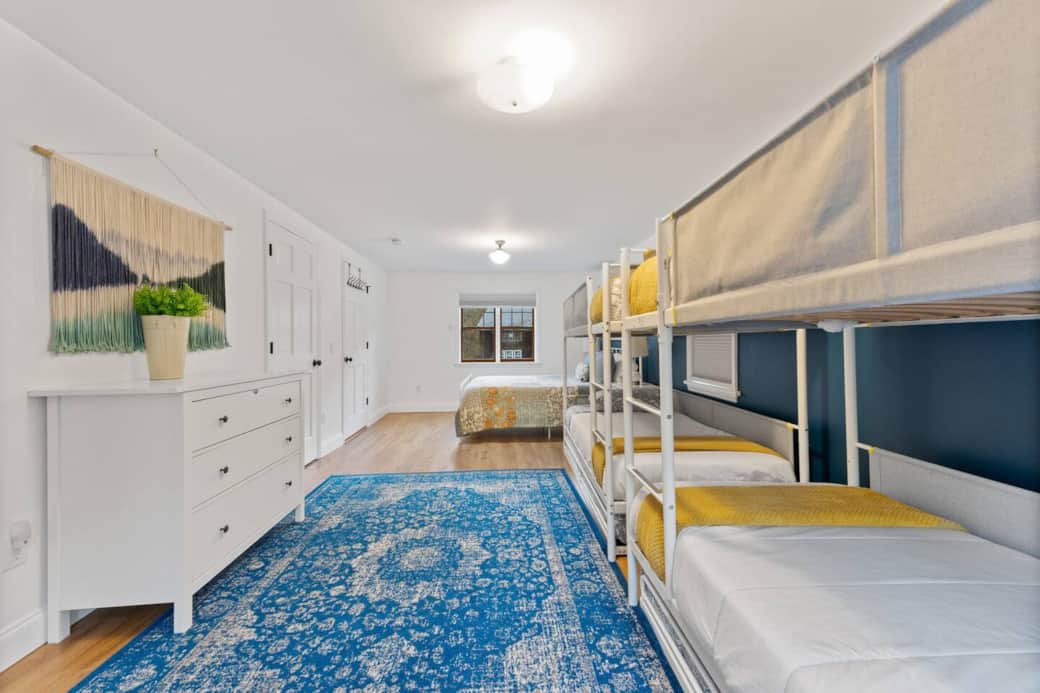 2 bunk beds, 2 trundles, 1 queen bed. Connects to bathroom. Huge room! 