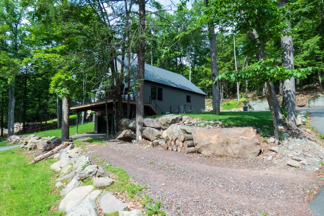 Chalet sits in a beautiful setting across the street from Swinging Bridge Lake