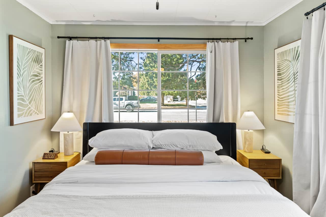 King Bedroom Retreat: Sunlit haven with plush bedding and modern decor for restful nights.